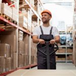 Warehouse worker walking through storage facility